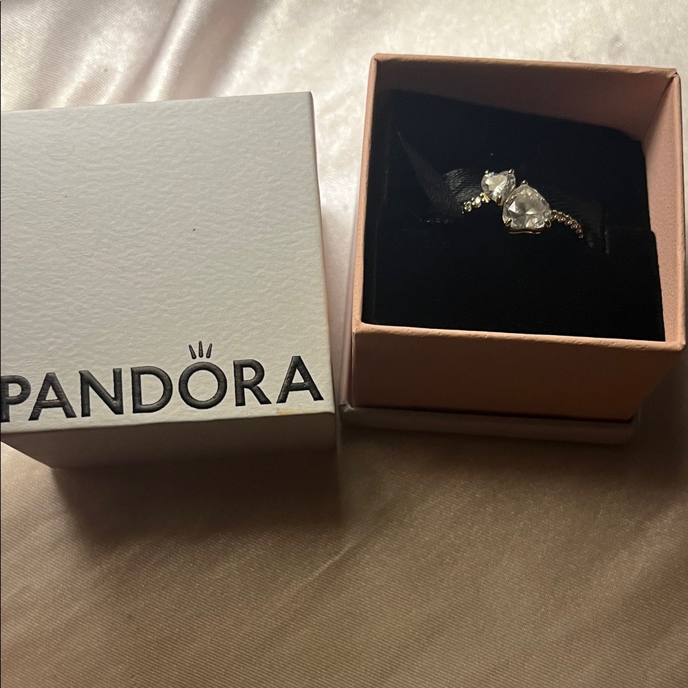 Never used gold pandora double heart ring.Perfect condition no scratches size8.5